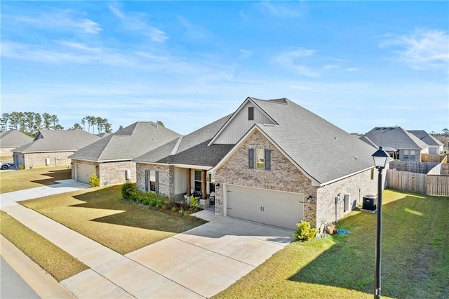 view of front facade with central AC unit, a garage, and a front lawn