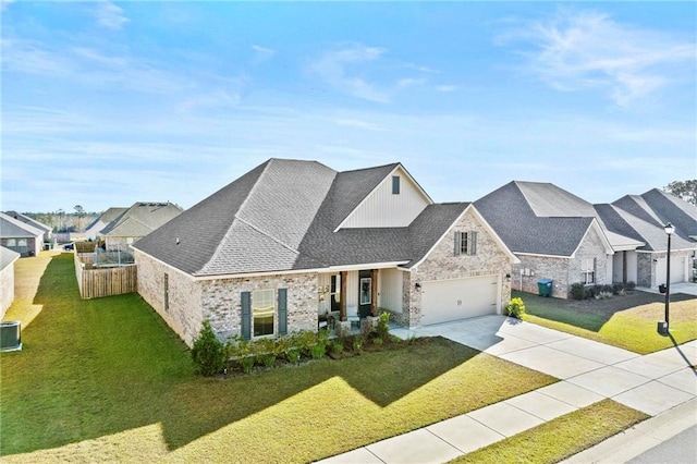 view of front of property featuring a front yard, central AC, and a garage