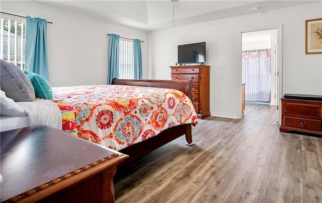 bedroom featuring multiple windows and hardwood / wood-style floors