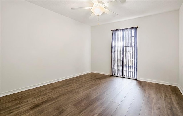 unfurnished room with ceiling fan and dark hardwood / wood-style flooring