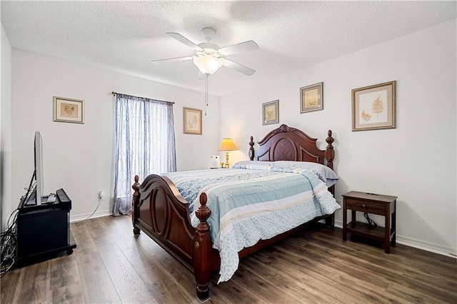 bedroom featuring ceiling fan, dark hardwood / wood-style floors, and a textured ceiling