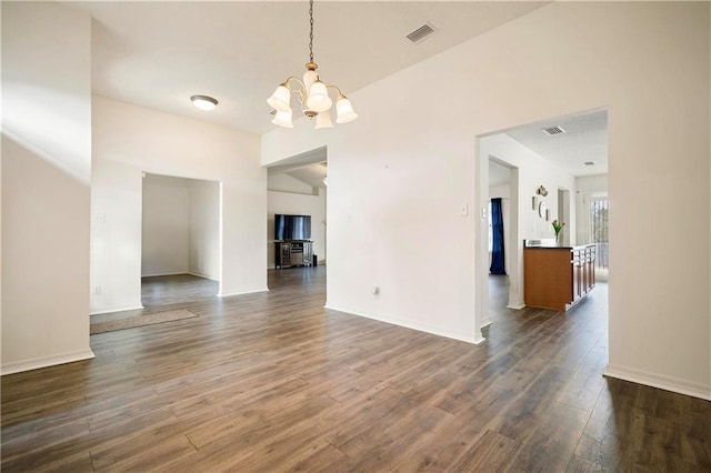 interior space with an inviting chandelier and dark hardwood / wood-style flooring