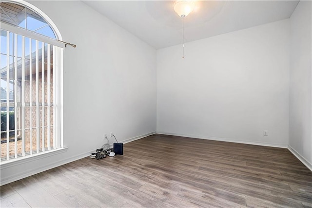 unfurnished room featuring hardwood / wood-style flooring and a healthy amount of sunlight