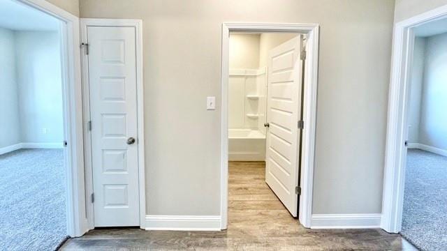 hallway featuring light carpet