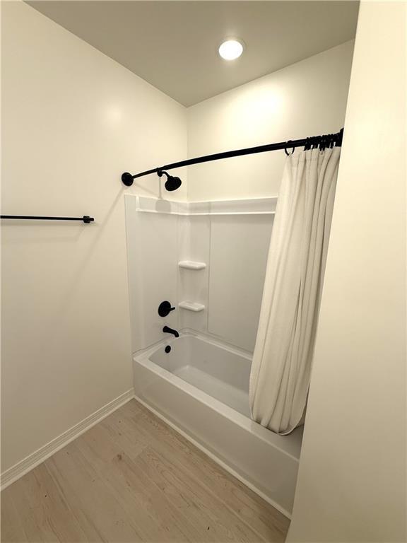 755 Cadillac Ave, Dauphin Island, AL 36528 - bathroom with wood finished floors and shower / bathtub combination with curtain