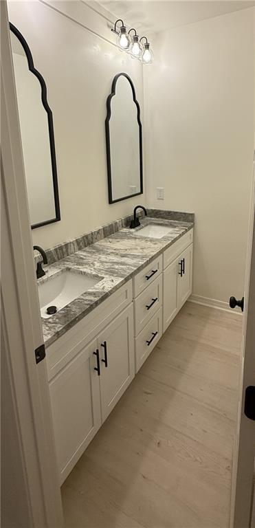 755 Cadillac Ave, Dauphin Island, AL 36528 - full bath featuring double vanity and wood finished floors