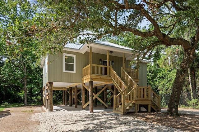 755 Cadillac Ave, Dauphin Island, AL 36528 - beach home with a carport, stairs, covered porch, dirt driveway, and a metal roof