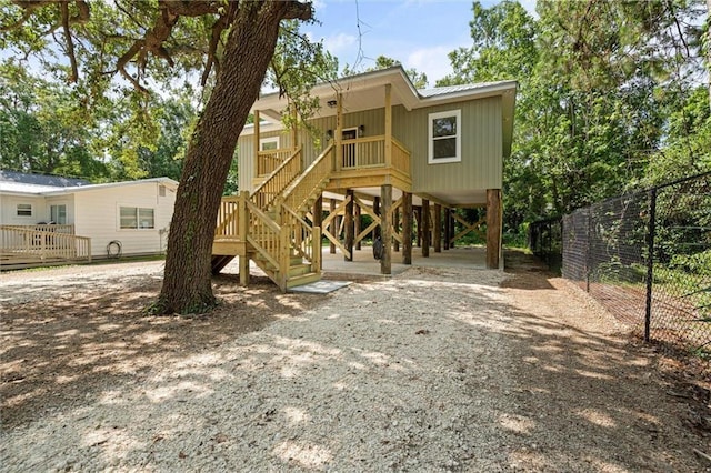 755 Cadillac Ave, Dauphin Island, AL 36528 - view of front of home with stairway, a carport, and dirt driveway