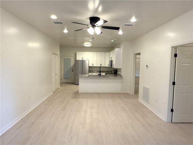 755 Cadillac Ave, Dauphin Island, AL 36528 - kitchen with appliances with stainless steel finishes, white cabinetry, ceiling fan, light wood-style floors, and a peninsula