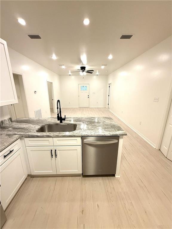 755 Cadillac Ave, Dauphin Island, AL 36528 - kitchen with stainless steel dishwasher, light stone countertops, white cabinets, and recessed lighting
