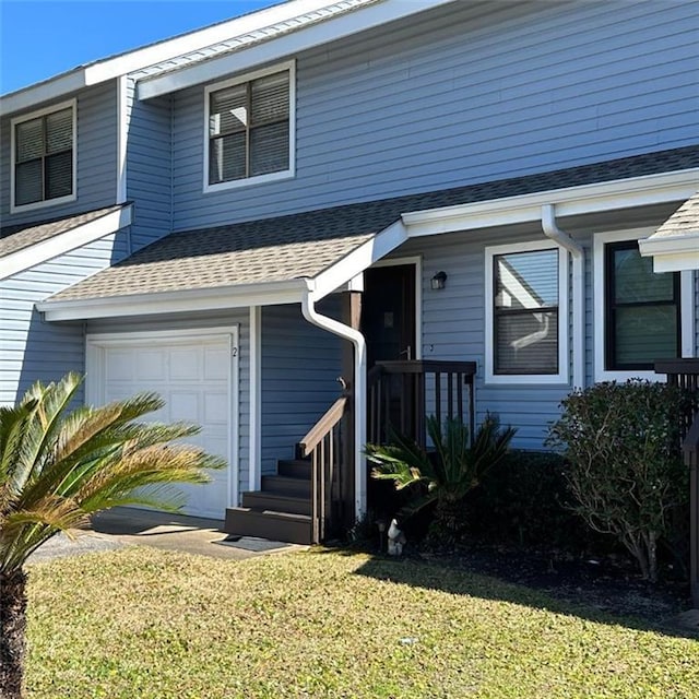 view of front of property with a garage and a front yard