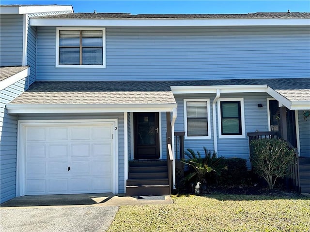 view of front of home with a front lawn and a garage