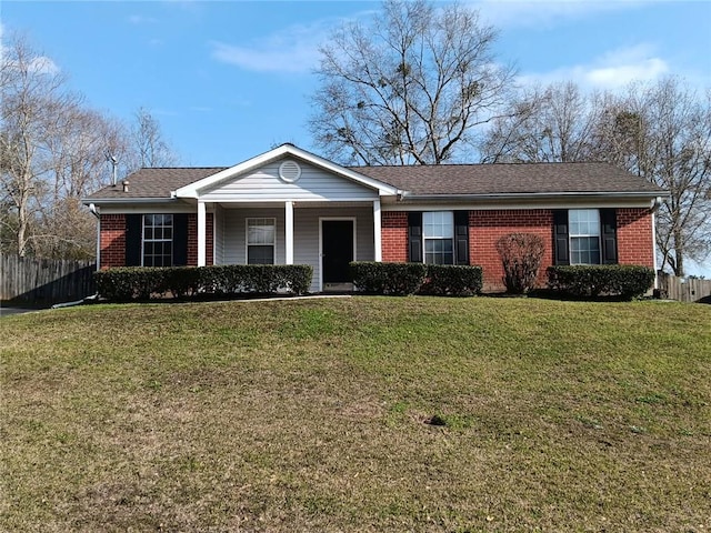 single story home with roof with shingles, a front yard, fence, and brick siding