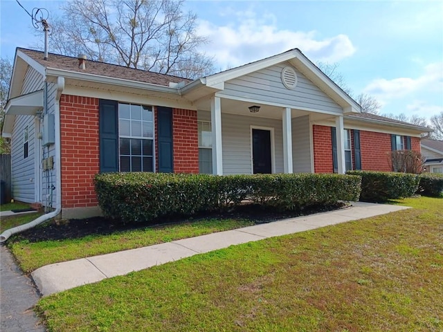 ranch-style home with brick siding and a front lawn