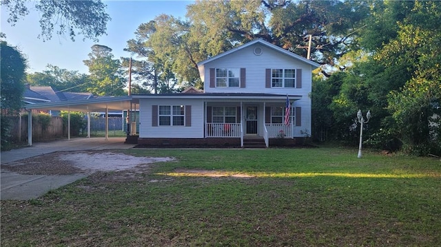 view of front facade with a carport, a front lawn, and covered porch