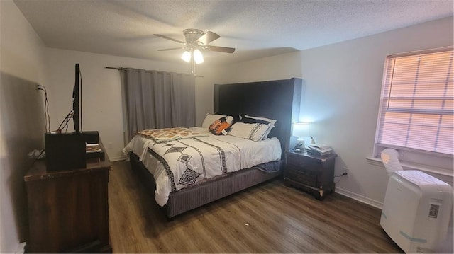 bedroom featuring a textured ceiling, ceiling fan, and dark wood-type flooring