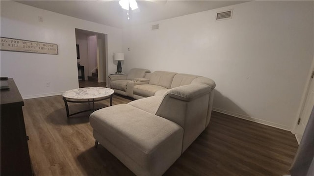 living room featuring dark hardwood / wood-style flooring and ceiling fan