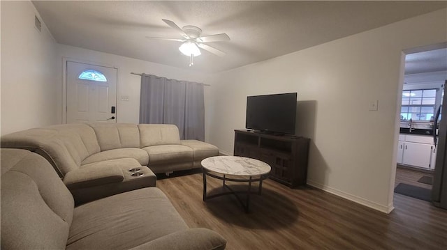 living room with wood-type flooring and ceiling fan