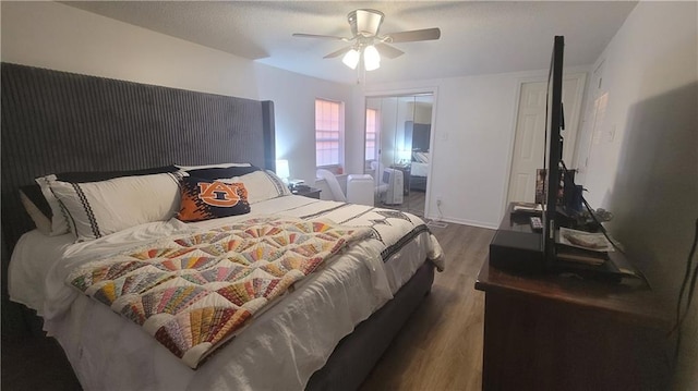 bedroom featuring ceiling fan and dark wood-type flooring