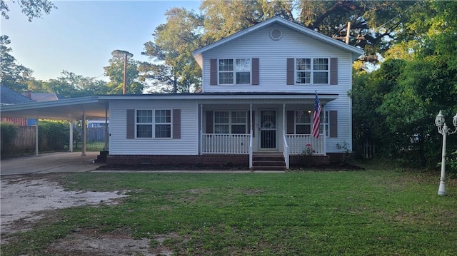 view of front of home with a carport, a porch, and a front yard