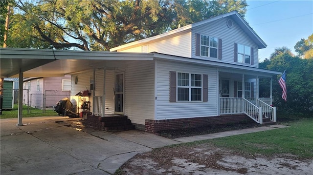 view of front facade featuring covered porch and a carport