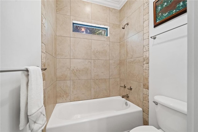 bathroom with tiled shower / bath, ornamental molding, and toilet