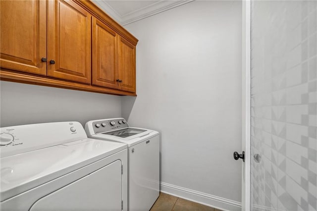 laundry room featuring cabinets, ornamental molding, and washer and dryer