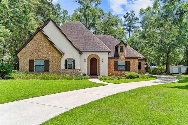 tudor house featuring a front yard