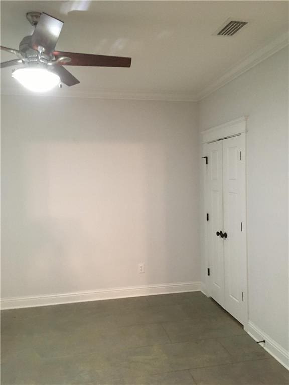 spare room featuring crown molding and ceiling fan