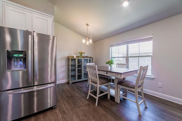 dining area featuring an inviting chandelier, baseboards, dark wood-style flooring, and lofted ceiling