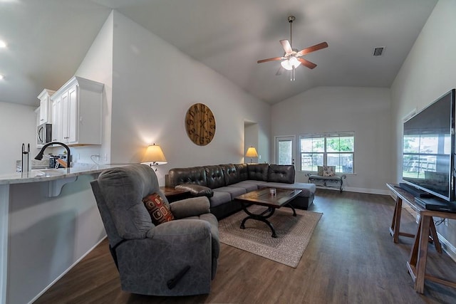 living area with ceiling fan, baseboards, lofted ceiling, dark wood-type flooring, and visible vents