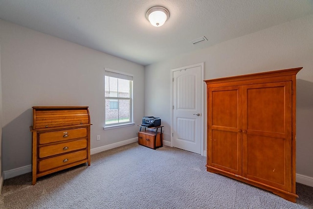 bedroom with baseboards, light colored carpet, and visible vents