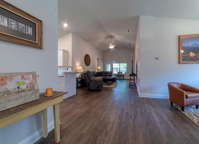 living room featuring ceiling fan, dark wood finished floors, baseboards, lofted ceiling, and visible vents
