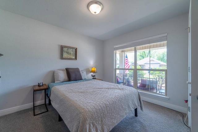 carpeted bedroom featuring baseboards