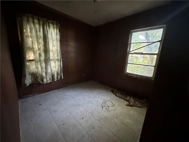 spare room featuring wood walls