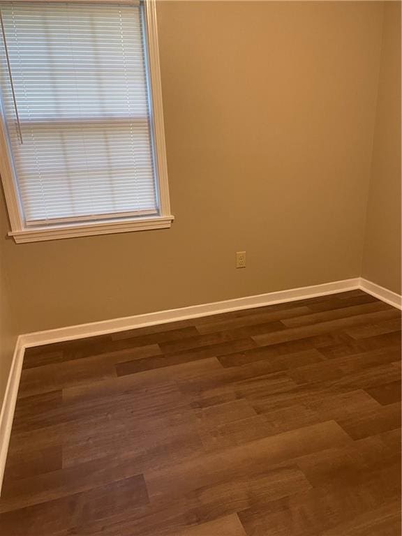 unfurnished room with dark hardwood / wood-style floors