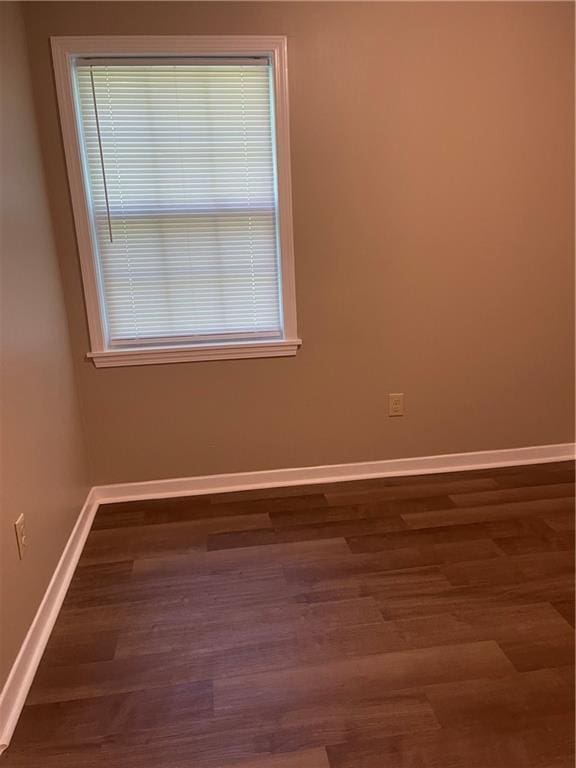 unfurnished room featuring dark wood-type flooring