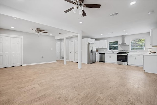 unfurnished living room featuring a ceiling fan, recessed lighting, light wood finished floors, and visible vents