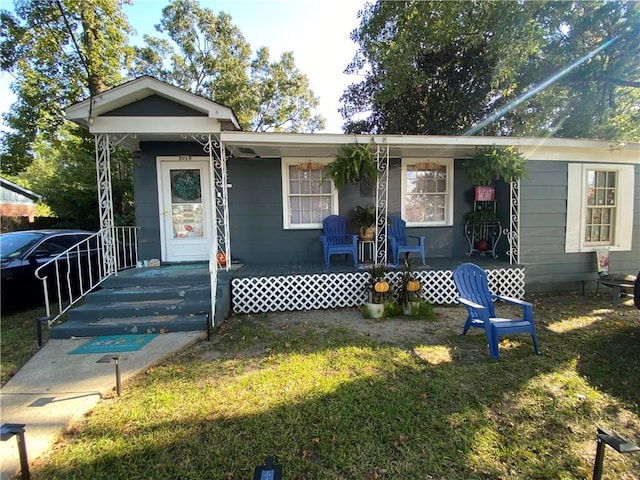 bungalow featuring a front yard and a porch