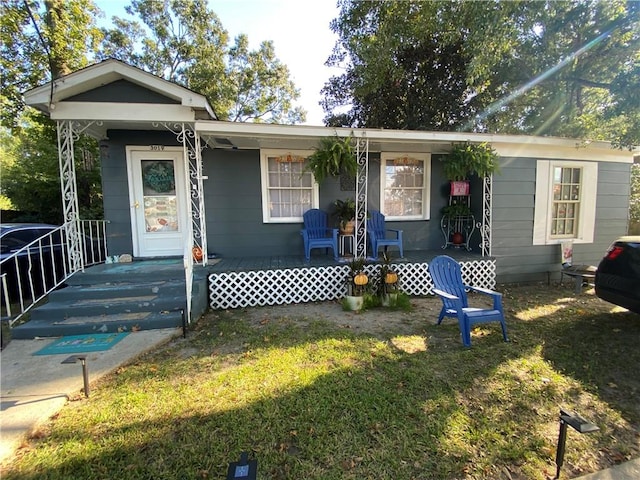 view of front of house featuring covered porch and a front lawn