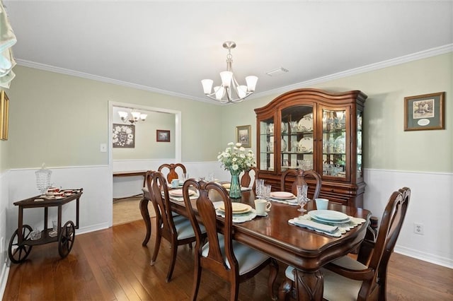 12850 Saeger Rd, Grand Bay, AL 36541 - dining room featuring a chandelier, a wainscoted wall, crown molding, and dark wood-style floors