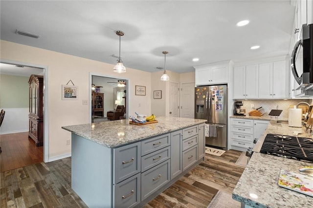 12850 Saeger Rd, Grand Bay, AL 36541 - kitchen with stainless steel refrigerator with ice dispenser, gray cabinetry, white cabinets, dark wood-type flooring, and light stone counters