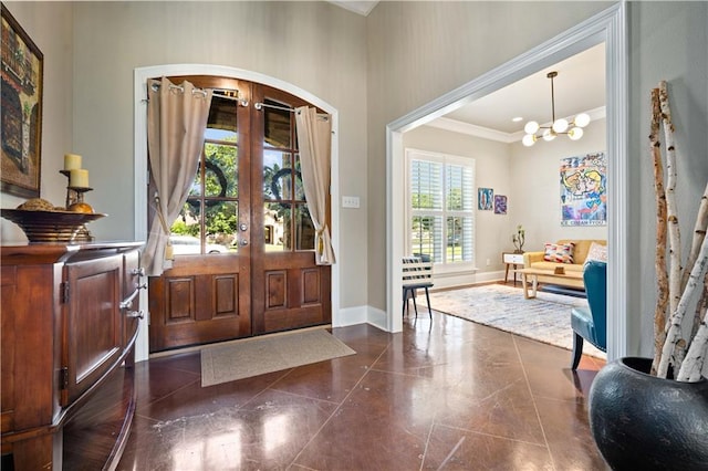 2217 Shandwick Dr, Mobile, AL 36695 - foyer entrance with arched walkways, crown molding, french doors, baseboards, and a chandelier