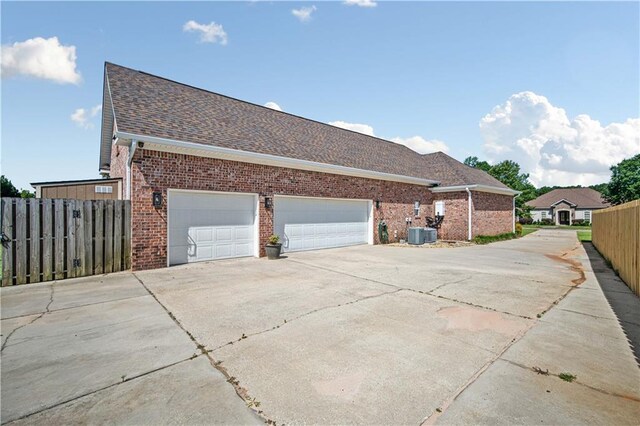 2217 Shandwick Dr, Mobile, AL 36695 - view of side of home featuring driveway, brick siding, roof with shingles, and an attached garage