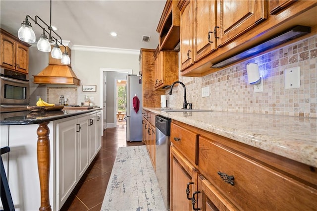 2217 Shandwick Dr, Mobile, AL 36695 - kitchen with brown cabinets, appliances with stainless steel finishes, light stone counters, tasteful backsplash, and a sink