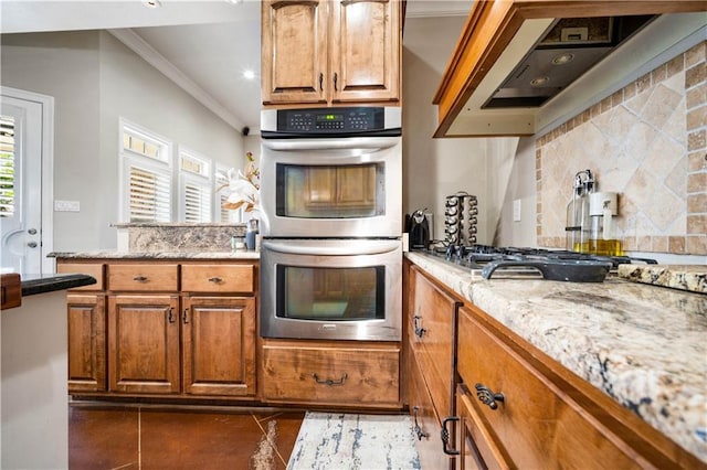 2217 Shandwick Dr, Mobile, AL 36695 - kitchen featuring appliances with stainless steel finishes, ornamental molding, wall chimney exhaust hood, decorative backsplash, and brown cabinets
