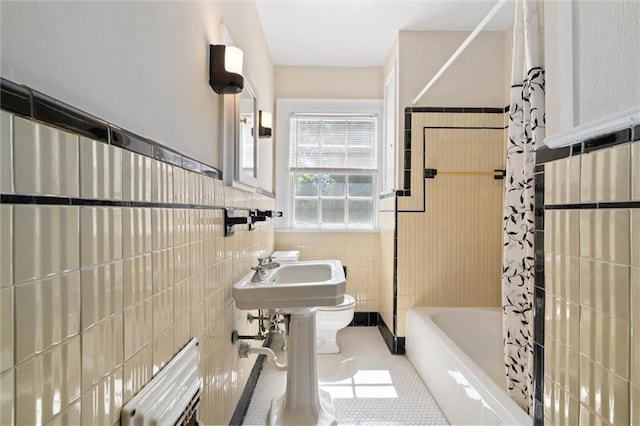 25 Benedict Pl, Mobile, AL 36606 - full bath with tile patterned flooring, toilet, tile walls, shower / bath combo with shower curtain, and a wainscoted wall