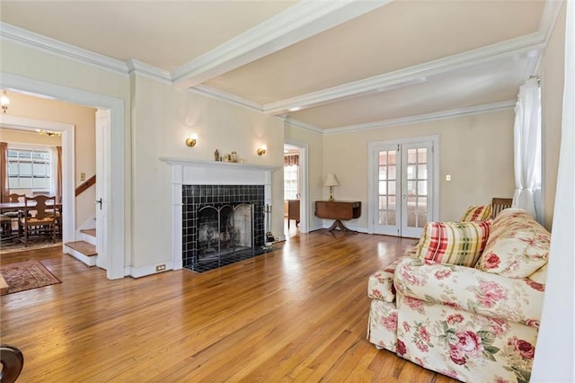 25 Benedict Pl, Mobile, AL 36606 - living area featuring wood finished floors, a tile fireplace, ornamental molding, stairs, and beam ceiling