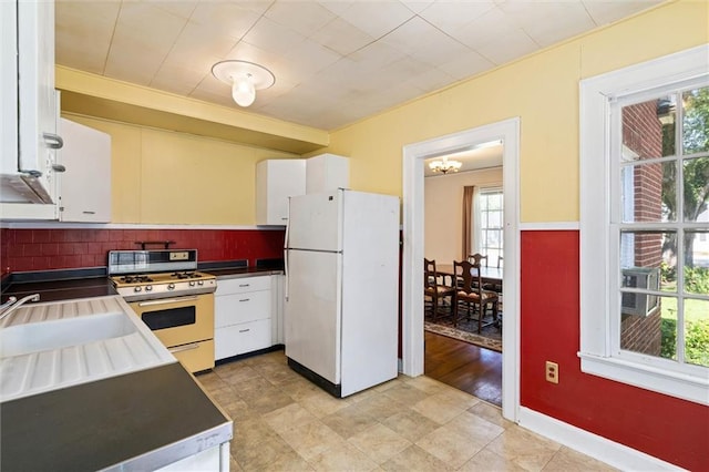 25 Benedict Pl, Mobile, AL 36606 - kitchen featuring white appliances, white cabinets, tasteful backsplash, and dark countertops