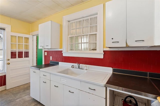 25 Benedict Pl, Mobile, AL 36606 - kitchen featuring a sink, white cabinets, and tasteful backsplash